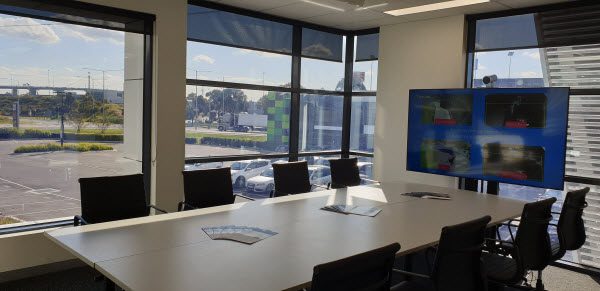 Empty chairs and table and monitor inside a meeting room