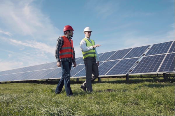 Two male electrician workers in reflective vests