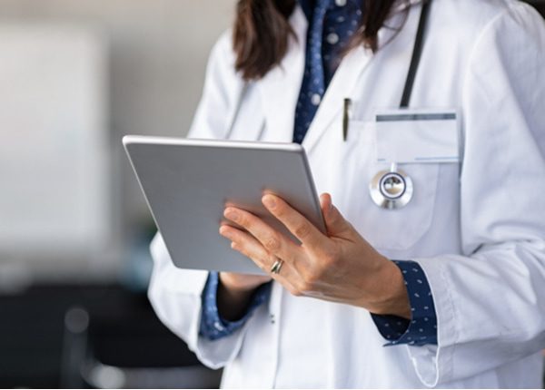 Woman doctor hands using digital tablet at clinic