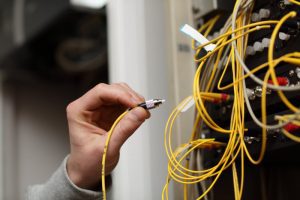 technician connecting fiber optic in a server
